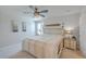 Neutral main bedroom featuring a ceiling fan, an ensuite bathroom, carpet, and a large window at 307 Fox Gap Rd, Summerville, SC 29486