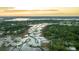Panoramic aerial view of waterfront homes with private docks surrounded by lush green trees near the waterway at 3130 Pignatelli Cres, Mount Pleasant, SC 29466