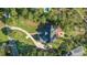 Aerial view of a private home with a large manicured lawn, patio and long driveway surrounded by lush green trees at 3130 Pignatelli Cres, Mount Pleasant, SC 29466