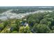 Aerial view of a two-story home with manicured lawn nestled within a lush green forest setting near the waterway at 3130 Pignatelli Cres, Mount Pleasant, SC 29466