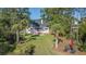 Aerial view of the backyard featuring mature trees, screened porch, deck, and outside seating at 3130 Pignatelli Cres, Mount Pleasant, SC 29466