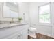 Bathroom features a granite countertop, white cabinets, and natural light from the window at 3130 Pignatelli Cres, Mount Pleasant, SC 29466
