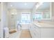 Bright bathroom features a glass enclosed shower, soaking tub, and white marble counters at 3130 Pignatelli Cres, Mount Pleasant, SC 29466