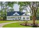 Charming two-story home with a manicured lawn, mature trees, and a traditional design aesthetic at 3130 Pignatelli Cres, Mount Pleasant, SC 29466