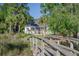 Charming home exterior showcasing a screened porch, wooden walkway, and picturesque surroundings at 3130 Pignatelli Cres, Mount Pleasant, SC 29466