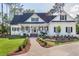Elegant home featuring a welcoming front porch, manicured lawn, and beautiful landscaping at 3130 Pignatelli Cres, Mount Pleasant, SC 29466