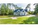Stately home with a circular driveway, lush lawn, and mature trees for added privacy at 3130 Pignatelli Cres, Mount Pleasant, SC 29466