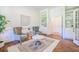 Bright living room with built-in bookshelves, hardwood floors, and comfortable seating at 3130 Pignatelli Cres, Mount Pleasant, SC 29466