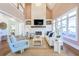 Inviting living room with stone fireplace, built-in shelving, and large windows for ample natural light at 3130 Pignatelli Cres, Mount Pleasant, SC 29466