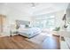 Bright main bedroom featuring a king bed, tray ceilings, and an abundance of natural light at 3130 Pignatelli Cres, Mount Pleasant, SC 29466