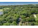 Stunning overhead view of a golf course community, lush greenery, and the ocean at 33 Painted Bunting Ln, Kiawah Island, SC 29455