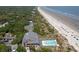 Stunning aerial view showcasing the oceanfront community with a pool, beach access, and lush greenery at 33 Painted Bunting Ln, Kiawah Island, SC 29455
