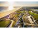 Scenic aerial view of a coastal golf course and community with ocean access at sunset at 33 Painted Bunting Ln, Kiawah Island, SC 29455