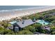 Beautiful aerial view featuring a beachfront community pool, ocean access, and verdant landscaping at 33 Painted Bunting Ln, Kiawah Island, SC 29455