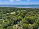 Scenic aerial view of a home nestled among trees, near a golf course and the ocean at 33 Painted Bunting Ln, Kiawah Island, SC 29455