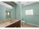 Bathroom with a glass block window, pink-marble sink, and a walk-in shower at 33 Painted Bunting Ln, Kiawah Island, SC 29455