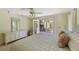 Bright bedroom with a ceiling fan, white bedding, and sliding doors to the deck at 33 Painted Bunting Ln, Kiawah Island, SC 29455