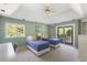 Bedroom with 2 beds, a ceiling fan, large windows and a sliding door to a balcony at 33 Painted Bunting Ln, Kiawah Island, SC 29455