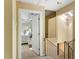 Hallway leading to a bedroom and staircase with a skylight and chandelier at 33 Painted Bunting Ln, Kiawah Island, SC 29455