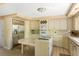Spacious kitchen with stainless steel refrigerator, tile countertops, and plenty of storage space at 33 Painted Bunting Ln, Kiawah Island, SC 29455