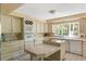 Well-equipped kitchen with tile countertops, ample cabinetry, and modern appliances at 33 Painted Bunting Ln, Kiawah Island, SC 29455