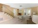 Cozy living room with carpet, staircase, and natural light, creating a welcoming ambiance at 33 Painted Bunting Ln, Kiawah Island, SC 29455