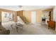 Bright living room with staircase, neutral decor, and seamless transitions to other living spaces at 33 Painted Bunting Ln, Kiawah Island, SC 29455