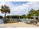 Inviting community pool surrounded by lounge chairs, palm trees, and beautiful landscaping at 33 Painted Bunting Ln, Kiawah Island, SC 29455