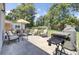 Inviting back patio with dining set, lounge chairs, grill, and spacious yard perfect for outdoor entertaining at 3428 Plaza Ln, North Charleston, SC 29420