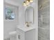 Chic bathroom boasts a modern vanity with gold accents, a stylish mirror, and attractive wall tiles at 3428 Plaza Ln, North Charleston, SC 29420