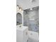Elegant bathroom features a modern vanity, blue-toned tile shower, and gold fixtures at 3428 Plaza Ln, North Charleston, SC 29420