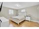 Bright bedroom with a queen bed, hardwood floors, and classic white furniture at 3428 Plaza Ln, North Charleston, SC 29420