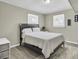 Neutral bedroom with wood paneling, two bright windows, a comfortable bed and simple decor at 3428 Plaza Ln, North Charleston, SC 29420