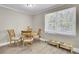 Bright dining area with a round table, four chairs, and a large window at 3428 Plaza Ln, North Charleston, SC 29420