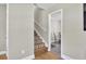 Hallway featuring hardwood floors, a staircase, and a view into an adjacent room at 3428 Plaza Ln, North Charleston, SC 29420