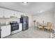 Bright kitchen with stainless steel appliances, white cabinets, and a dining area at 3428 Plaza Ln, North Charleston, SC 29420