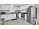 Well-lit kitchen featuring white cabinets, stainless steel appliances, and granite countertops at 3428 Plaza Ln, North Charleston, SC 29420
