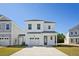 Charming two-story home featuring a single-car garage, a welcoming front porch, and a well-manicured front yard at 350 Chapman Cir, Goose Creek, SC 29445