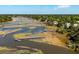 Scenic aerial view of a serene waterway with private docks, offering picturesque waterfront living amidst nature at 3508 Henrietta Hartford Rd, Mount Pleasant, SC 29466