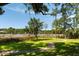 Beautiful backyard lawn with winding path, fire pit and dock at 3508 Henrietta Hartford Rd, Mount Pleasant, SC 29466