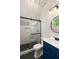 Beautiful bathroom featuring a glass shower door, sleek black hardware, and a blue vanity with white countertop at 3508 Henrietta Hartford Rd, Mount Pleasant, SC 29466