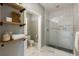 Stylish bathroom featuring a glass-enclosed shower, wood shelves, and hexagonal tile flooring at 3508 Henrietta Hartford Rd, Mount Pleasant, SC 29466