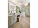 Gorgeous bathroom with stone floors, double vanity, chandelier and glass enclosed shower at 3508 Henrietta Hartford Rd, Mount Pleasant, SC 29466