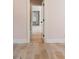 View from a bedroom with pink striped walls leading to a closet with shelving at 3508 Henrietta Hartford Rd, Mount Pleasant, SC 29466