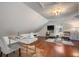 Comfortable bonus room featuring hardwood floors, shiplap walls, and a relaxed seating area at 3508 Henrietta Hartford Rd, Mount Pleasant, SC 29466