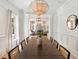 Stylish dining room featuring a large wooden table, designer lighting, and views into the living space at 3508 Henrietta Hartford Rd, Mount Pleasant, SC 29466