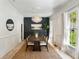 Elegant dining room featuring a large wooden table, stylish lighting, and neutral walls at 3508 Henrietta Hartford Rd, Mount Pleasant, SC 29466