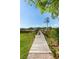 Scenic dock with lush green surroundings, leading to waterfront views and recreational opportunities at 3508 Henrietta Hartford Rd, Mount Pleasant, SC 29466