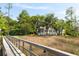 Charming home exterior with a view from the marshland, featuring a screened porch and lush landscaping at 3508 Henrietta Hartford Rd, Mount Pleasant, SC 29466
