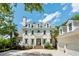 Stately home featuring blue shutters, dormer windows, and a brick walkway to the front door and two-car garage at 3508 Henrietta Hartford Rd, Mount Pleasant, SC 29466